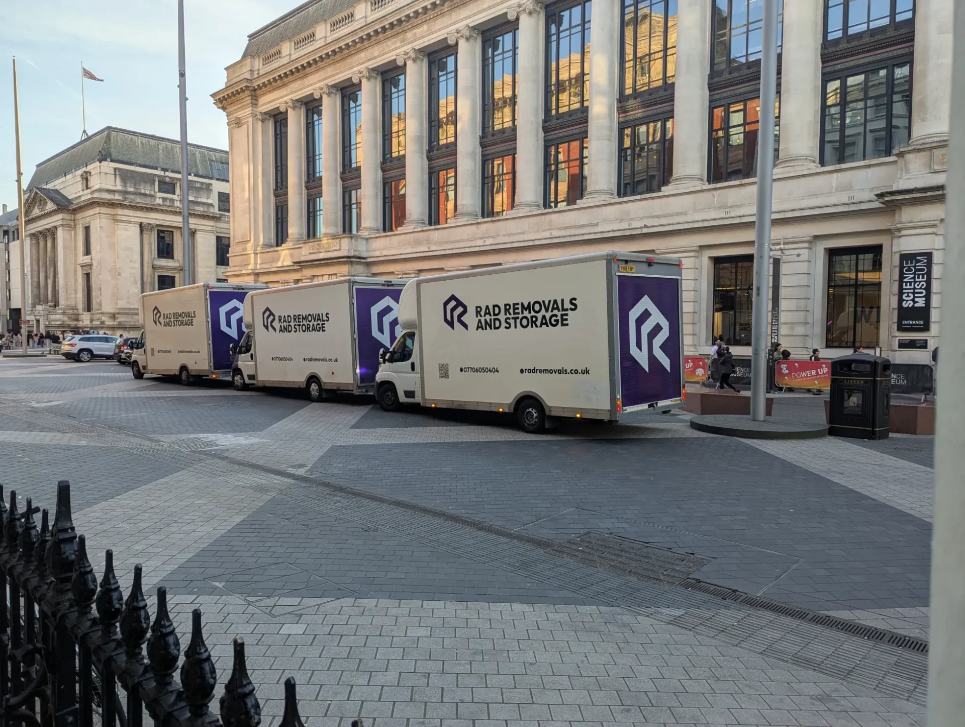 Rad Removals branded vans driving past the Science Museum in South Kensington, London